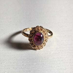 Elegant Gold Ring with Deep Purple Stone